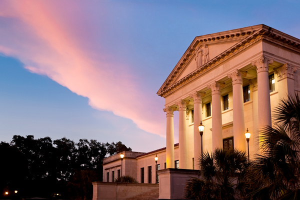 court building at dusk with colorful clouds
