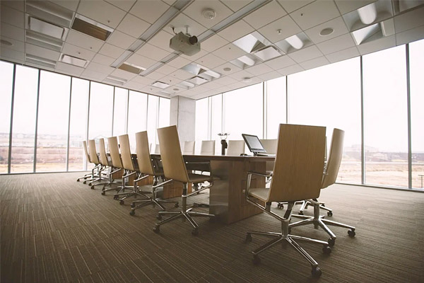 large modern conference table in open room with city views